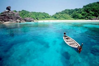 Long-tail boat at Donald Duck Bay, Similan Island no. 8 - photo courtesy of Tourist Authority of Thailand